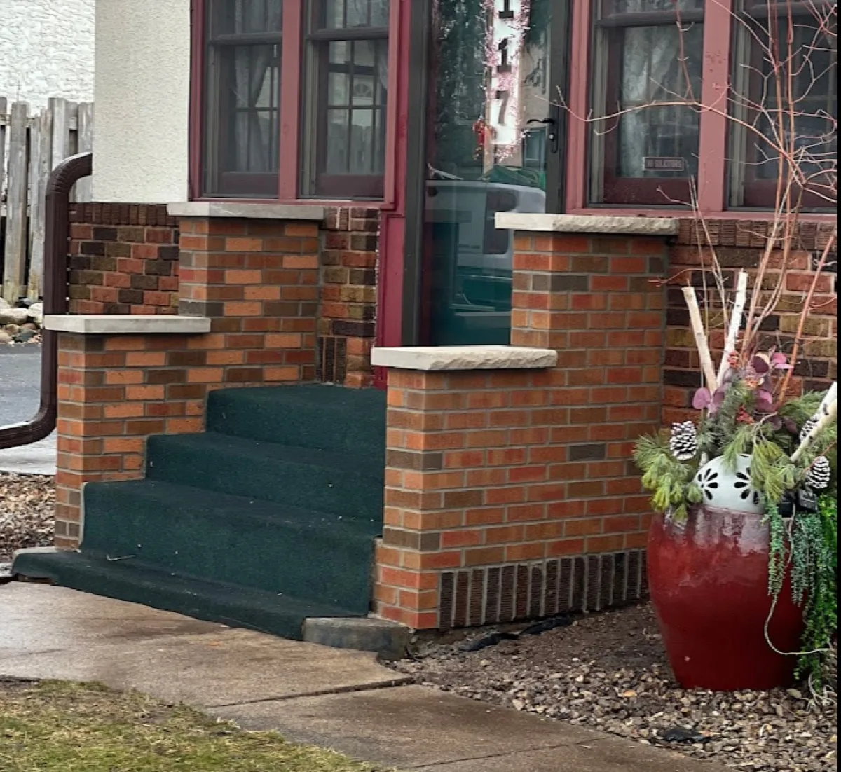 Brick porch piers and steps with stone caps